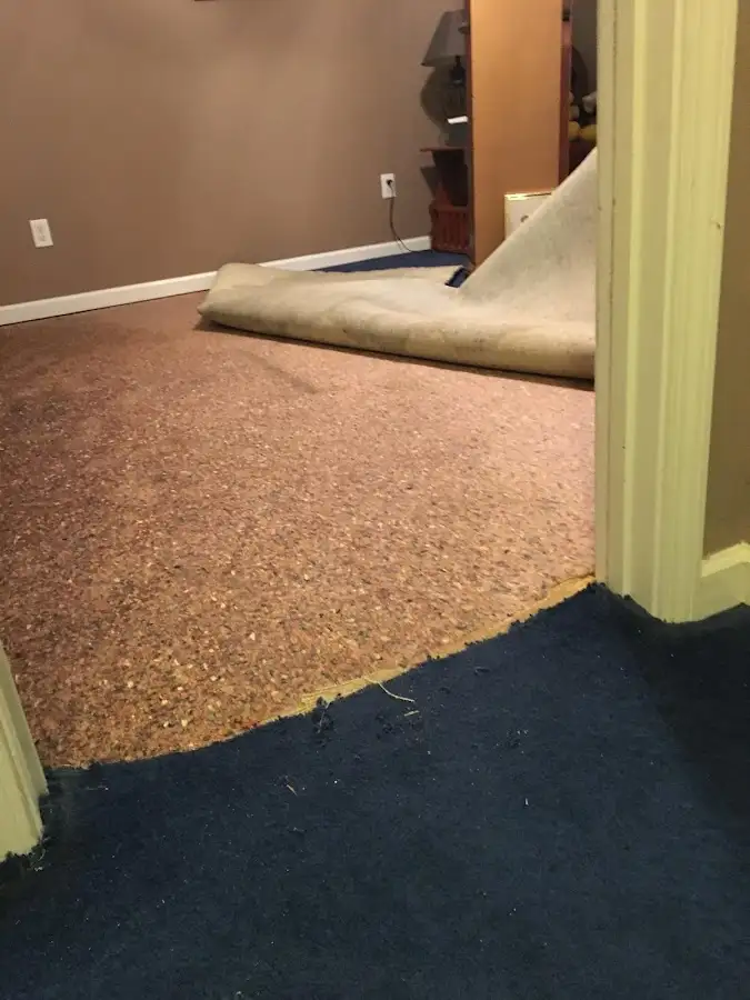 Carpet pad removal revealing water damage during Drying & Dehumidification in Sioux City